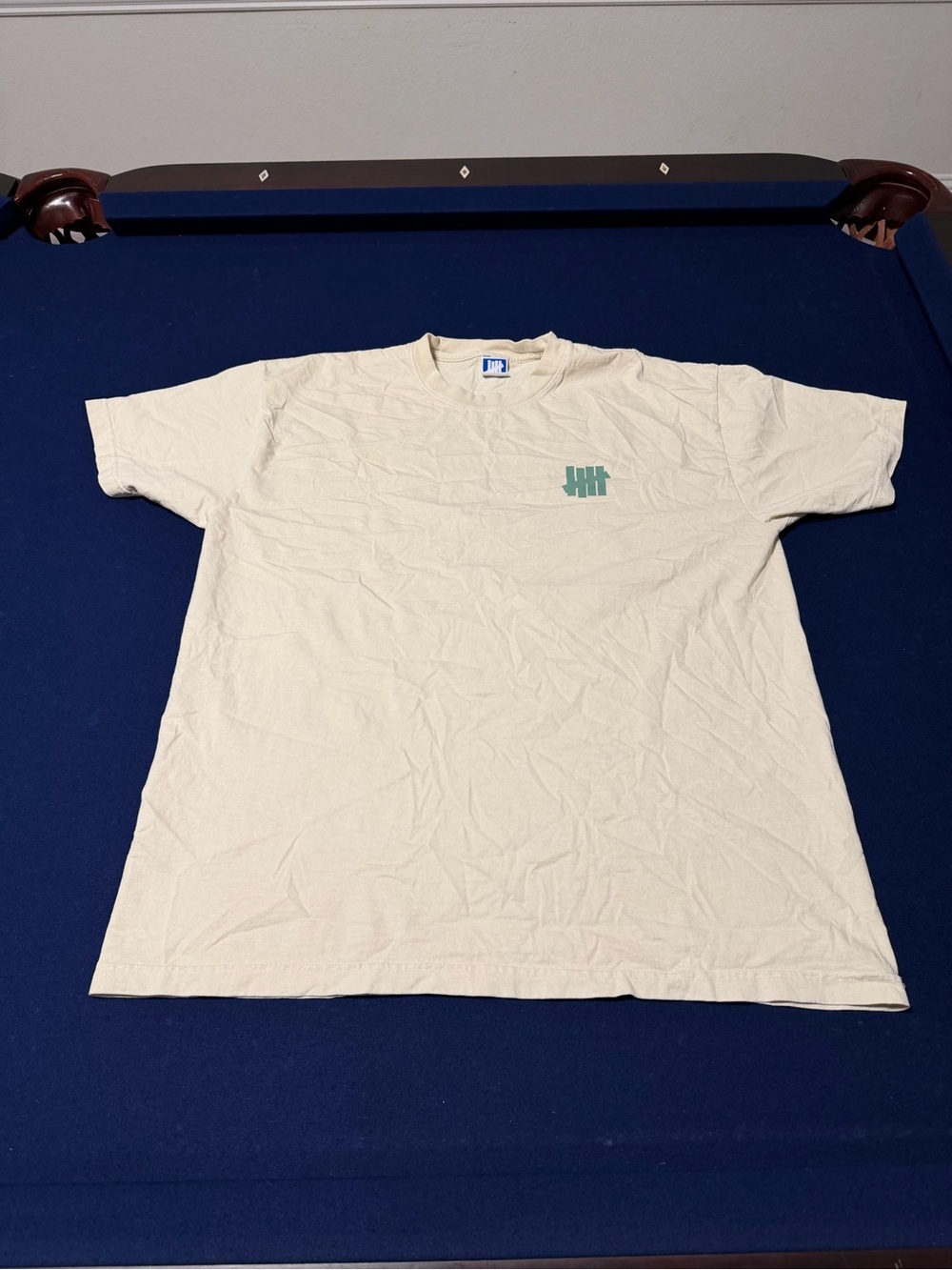 Undefeated Cream Short-Sleeve Tee with Green Logo